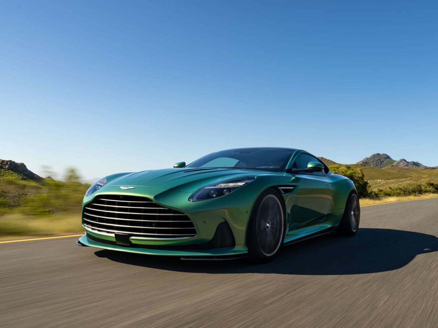 Aston Martin DB12 green driving on the road