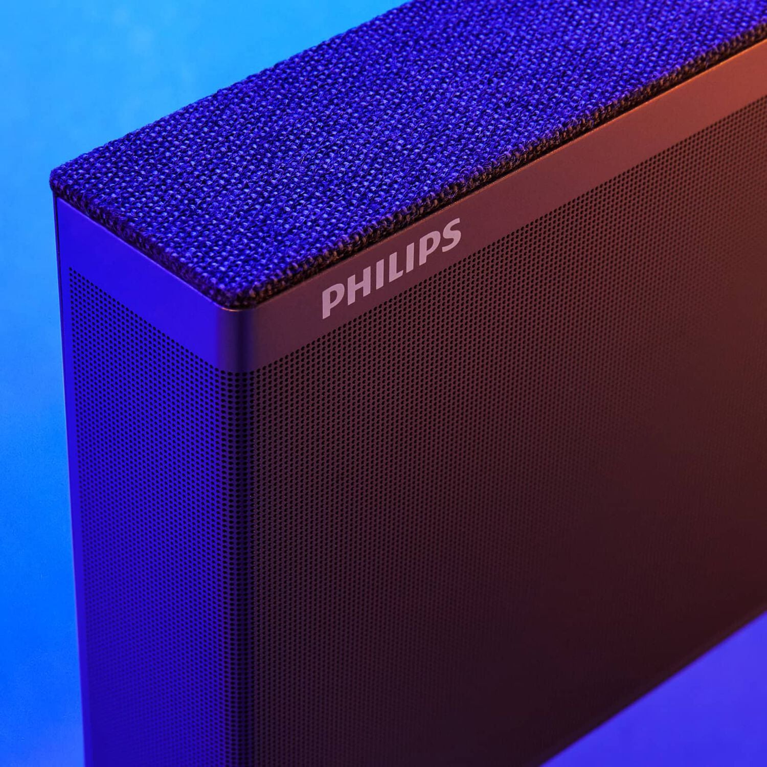 Black rectangular Philips speaker with blue background facing right