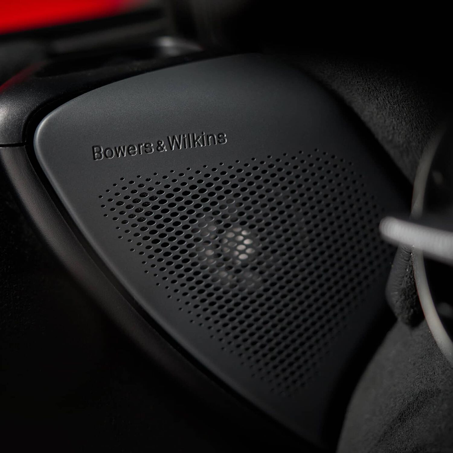 Black Bowers & Wilkins car speaker with visible speaker cutouts