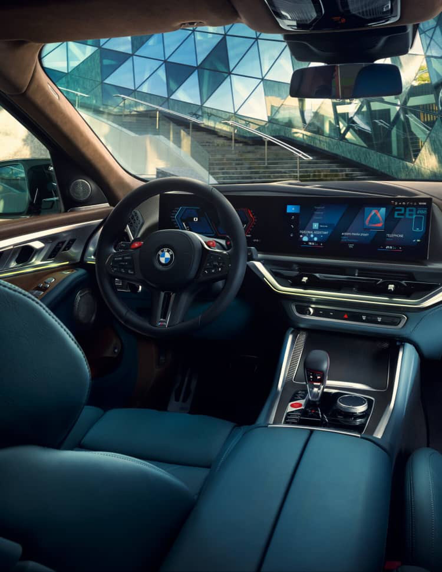 Interior of BMW car with black leather seats and wood dashboard