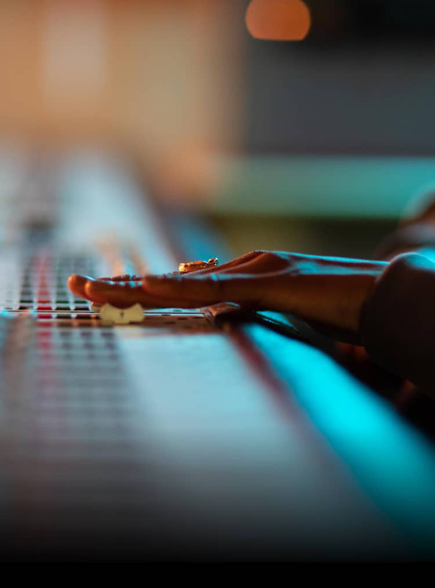 A person using a mixing board