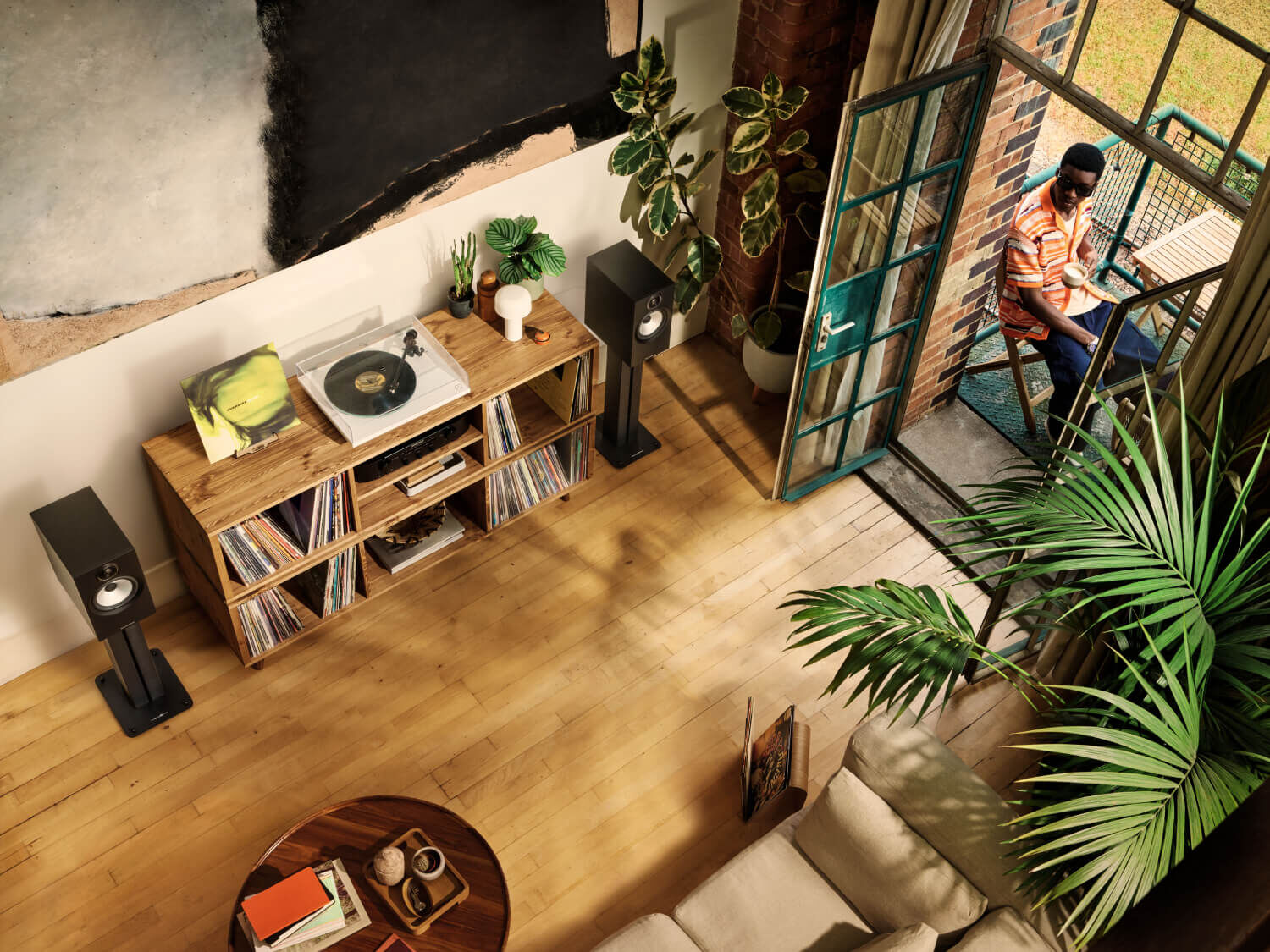 True Sound - turntables and speakers in a living room with patio doors open