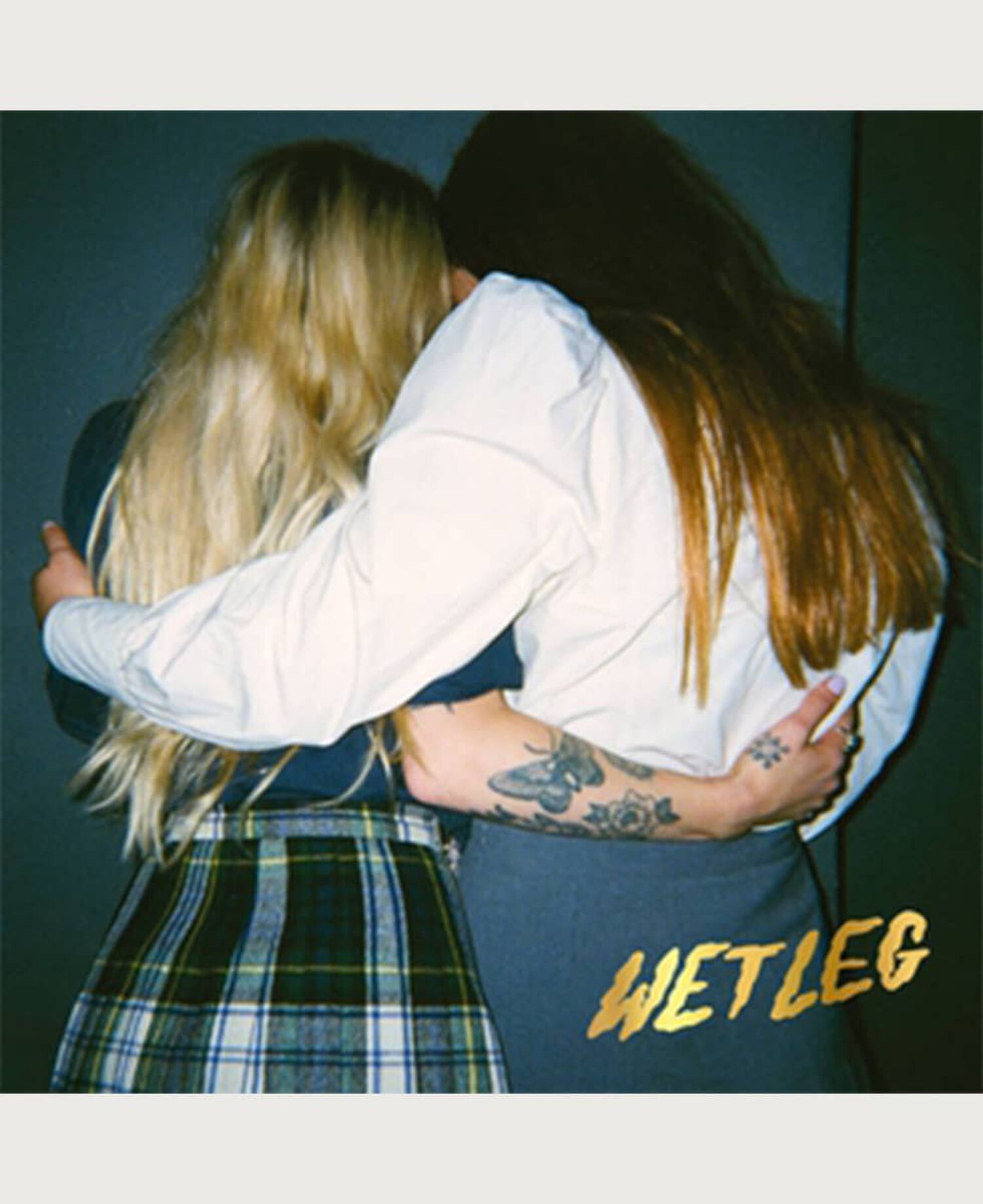 2 woman embracing one another