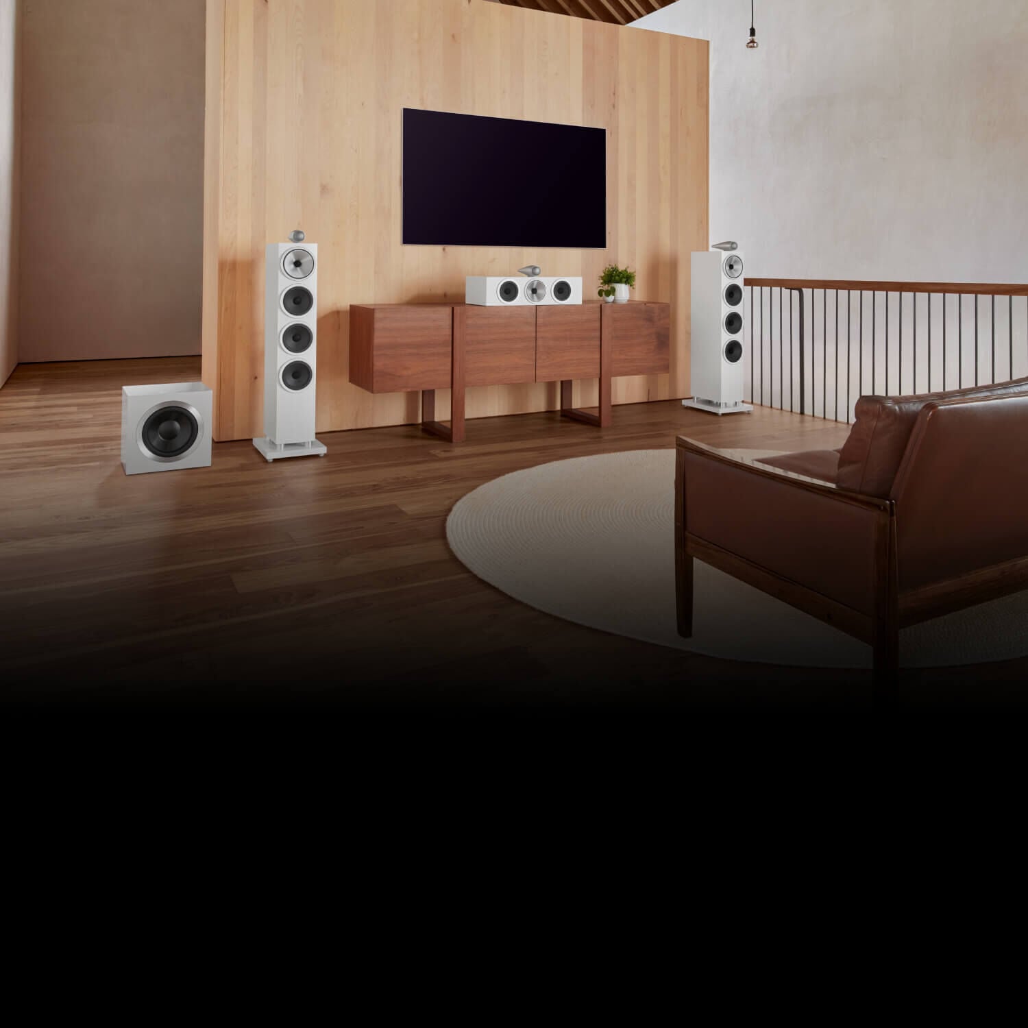 White 700 series speakers under a television