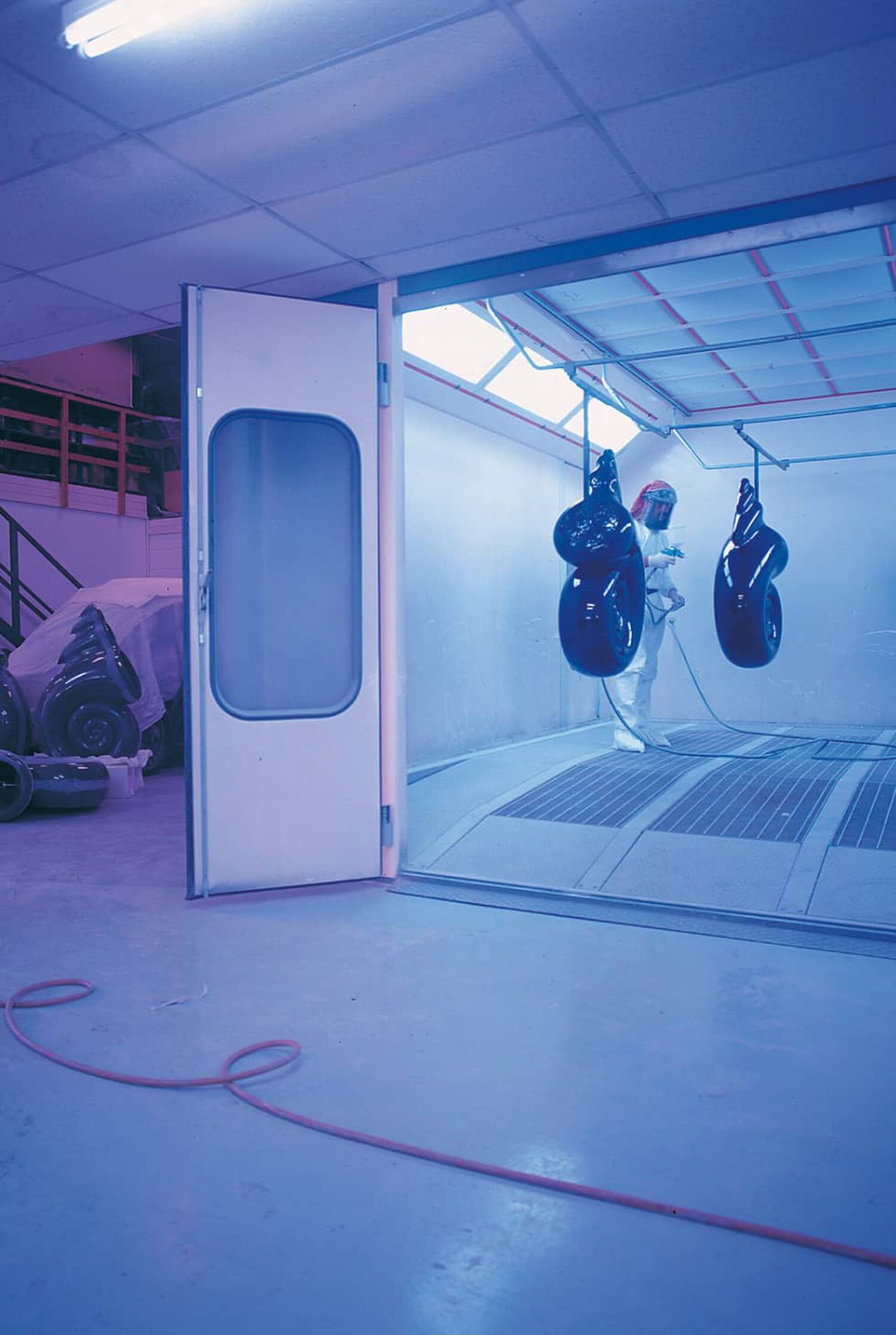 Nautilus speakers hanging in chamber being painted