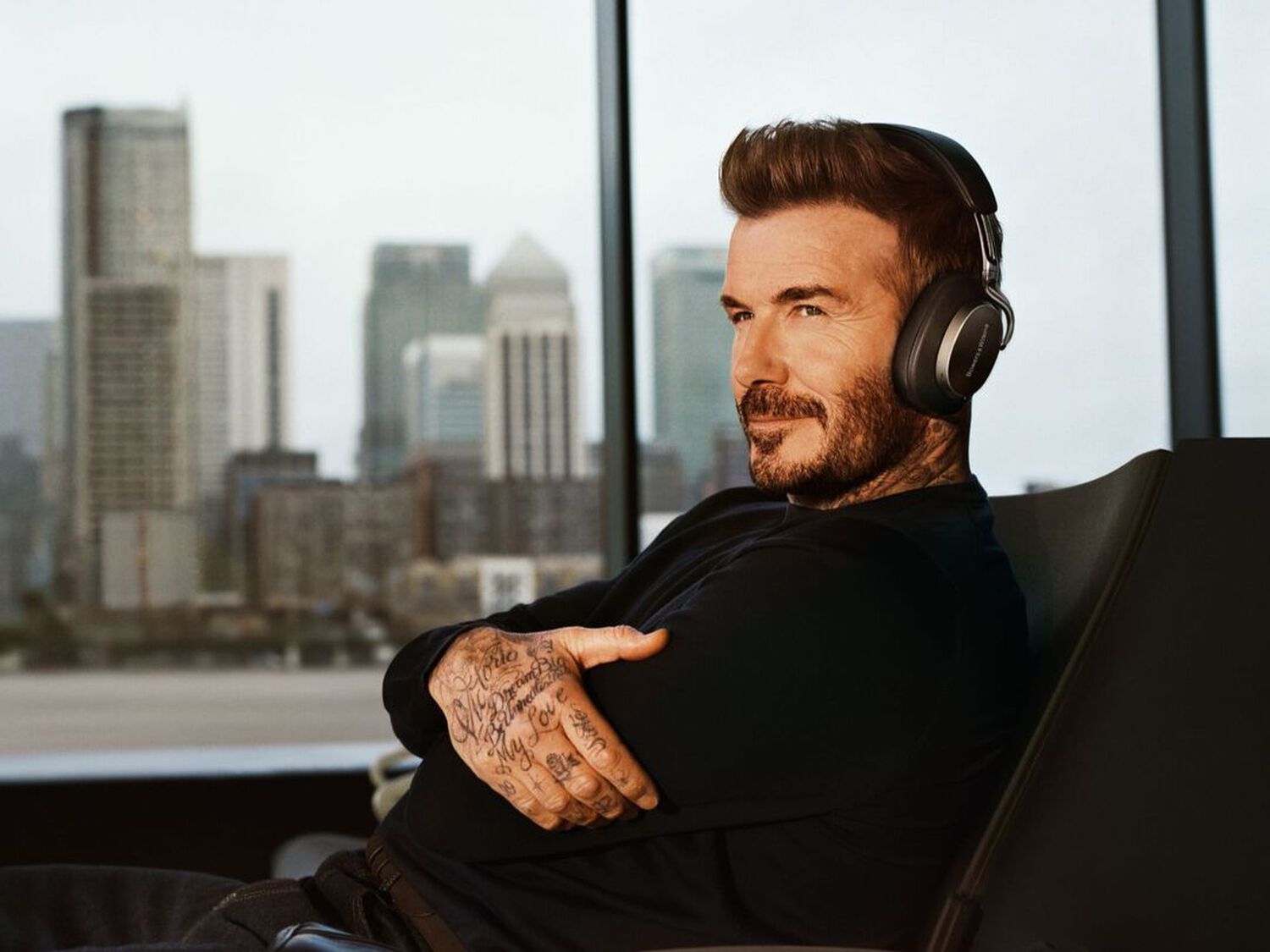 David Beckham wearing black headphones facing left