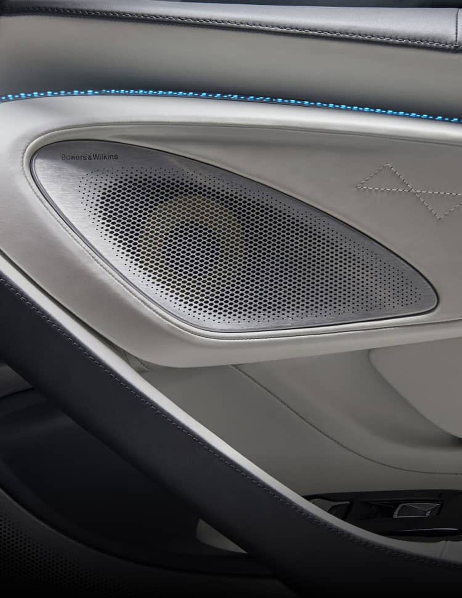 Bowers & Wilkins speaker on the inside of left door with white leather interior