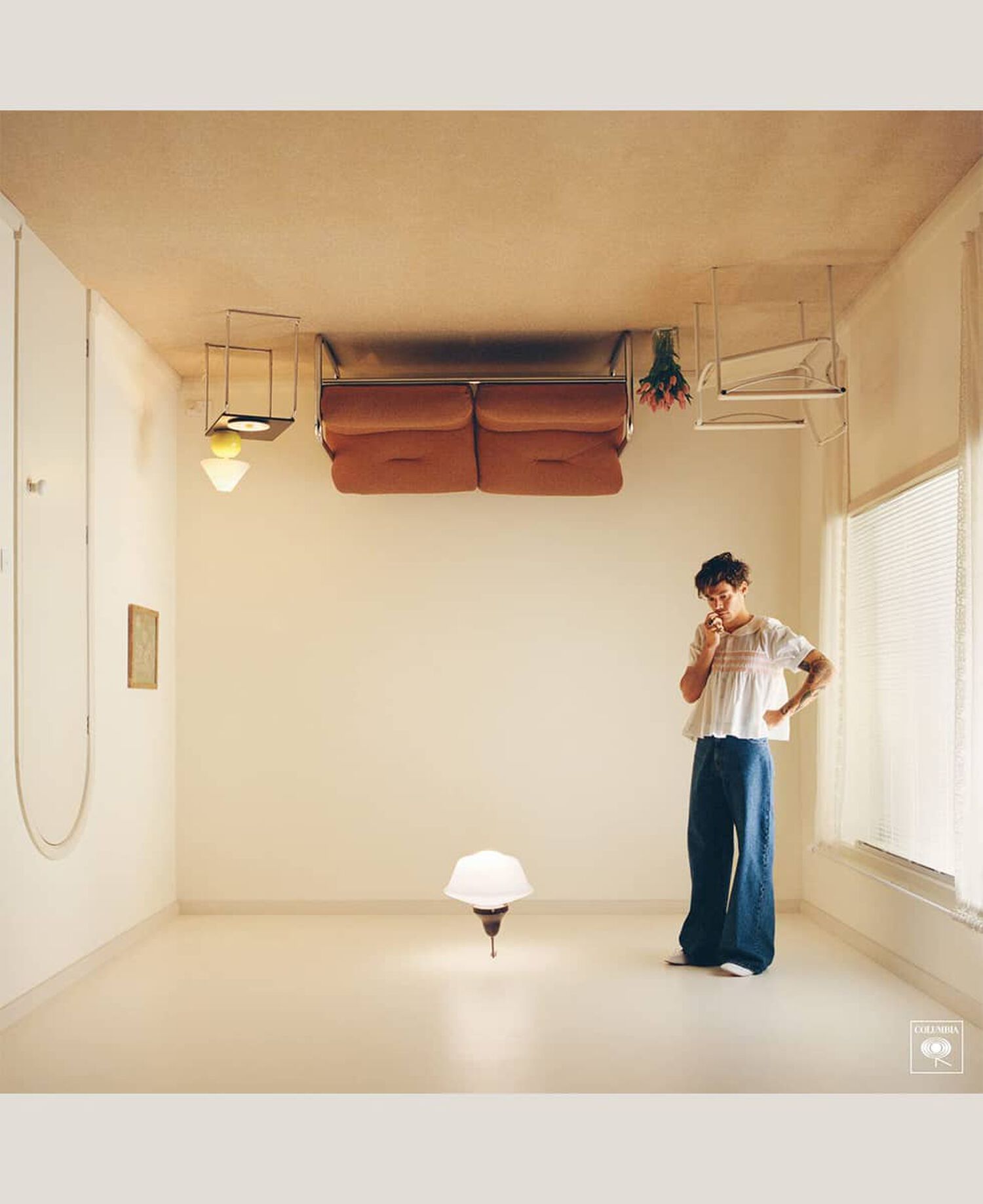Man standing upright in upside down living room