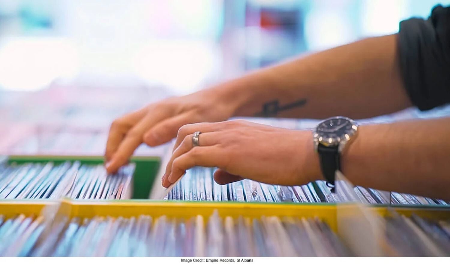 2 hands rifling through vinyl records