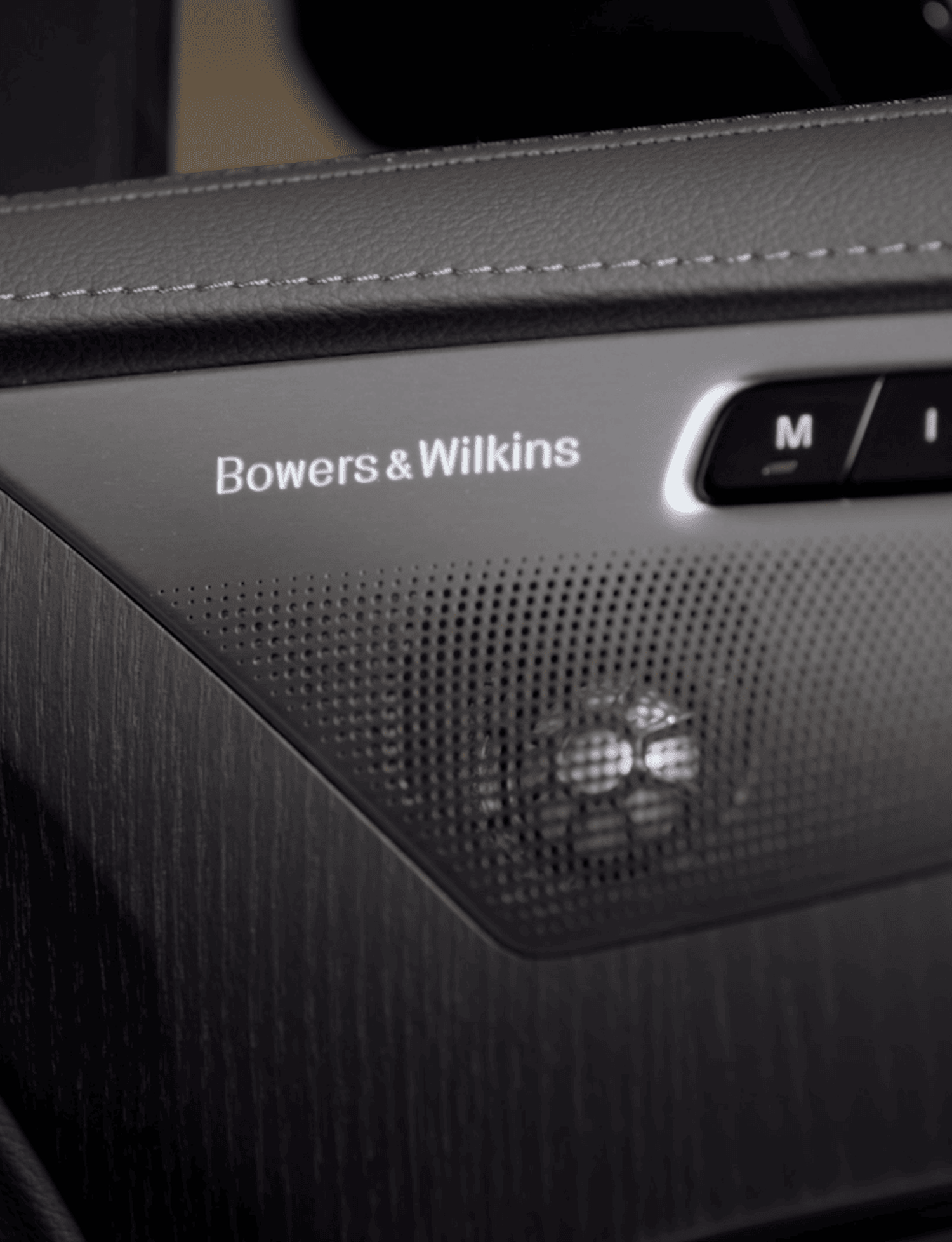 Bowers & Wilkins speaker inside car with gray leather