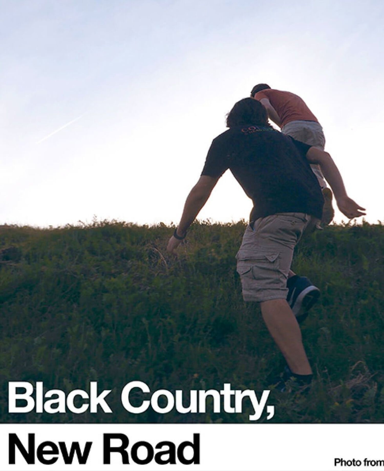 2 people running in grassy field