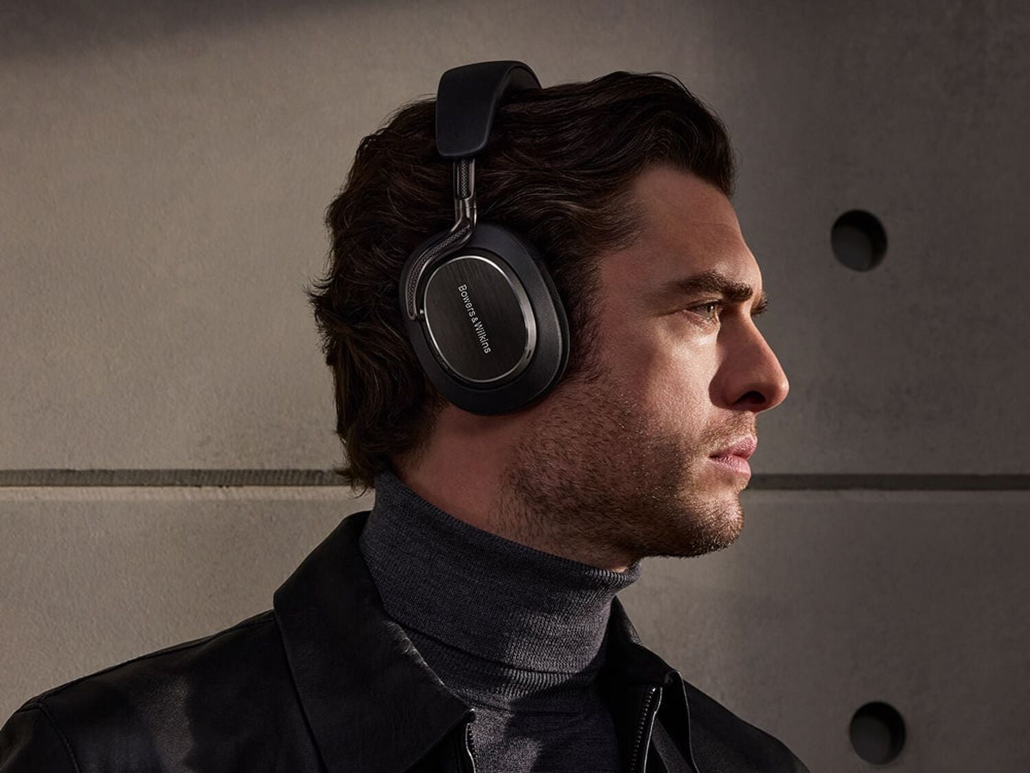 Man wearing black Px8 S2 facing left with concrete background