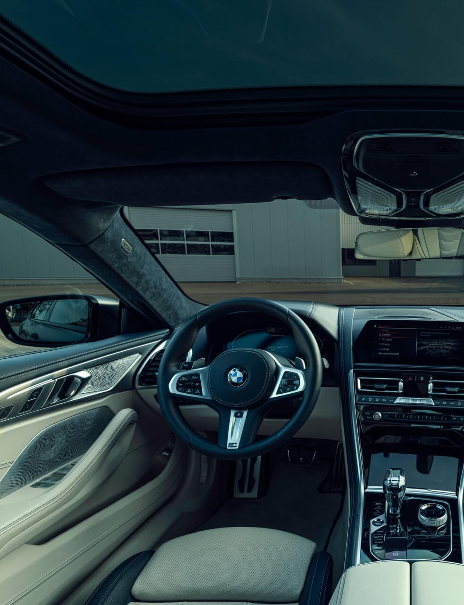 Driver side interior of BMW car with tan leather seats