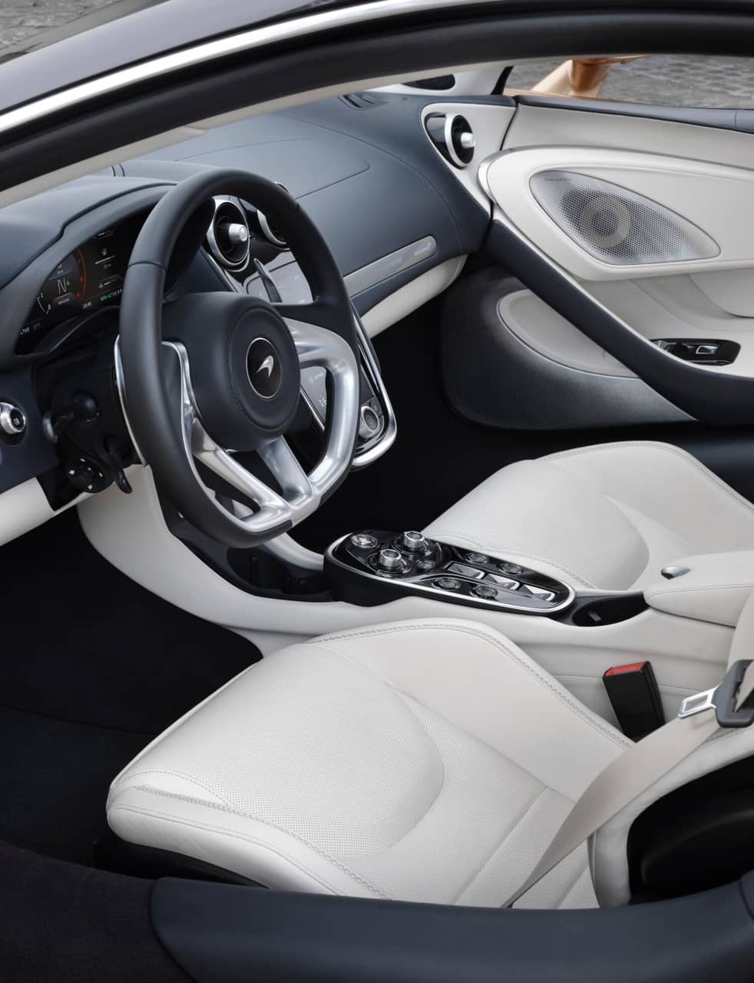 Interior of McLaren car with white leather seats