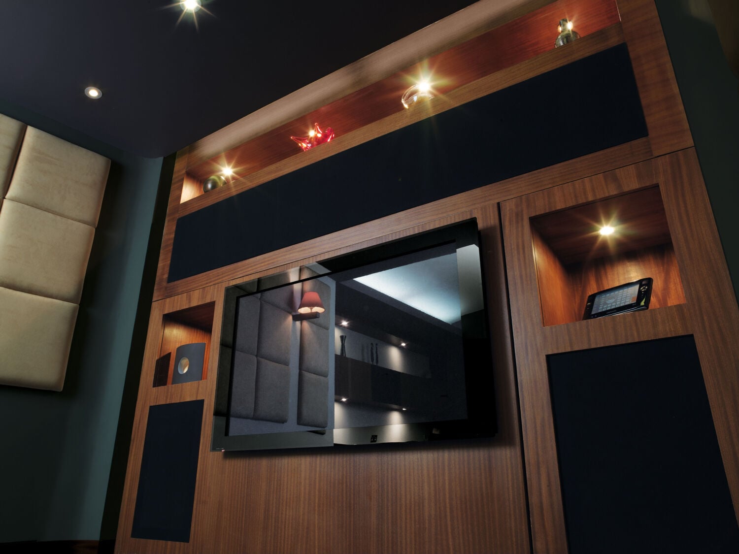 Home theater with speakers imbedded in wooden wall panels