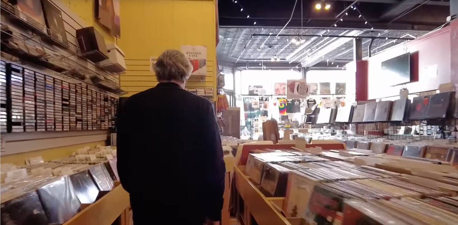 Man walking through record store