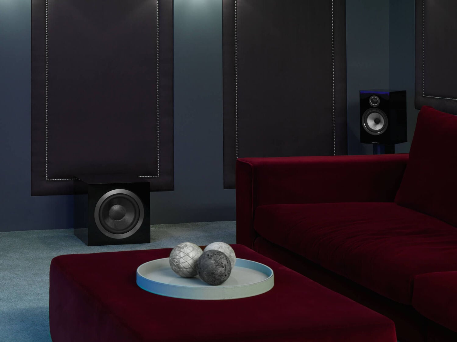 DB Series in a dim room with a red couch