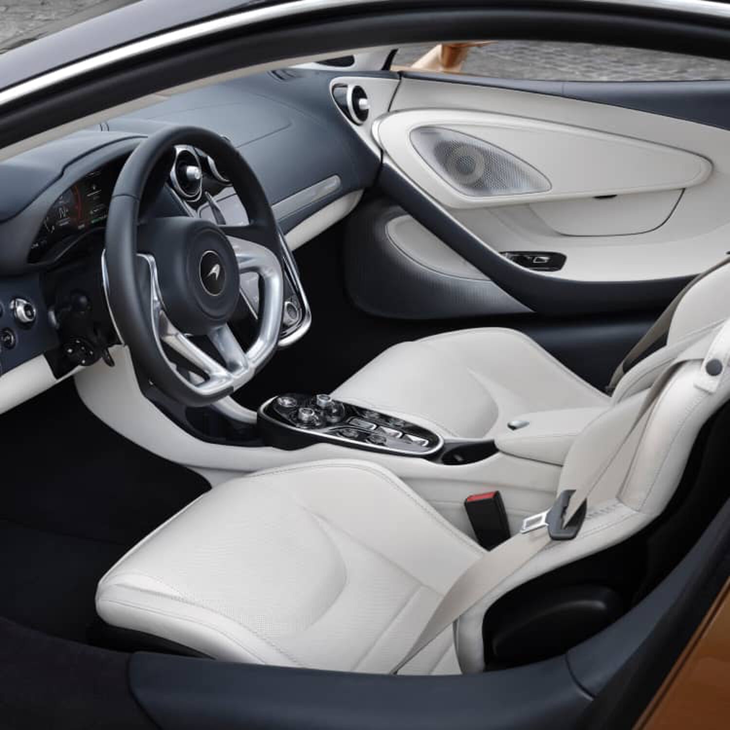 Interior of McLaren car with white leather seats