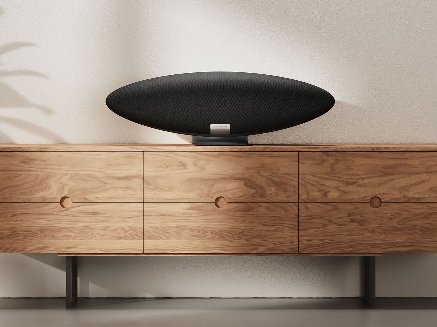 Black Zeppelin pro speaker on wooden media console