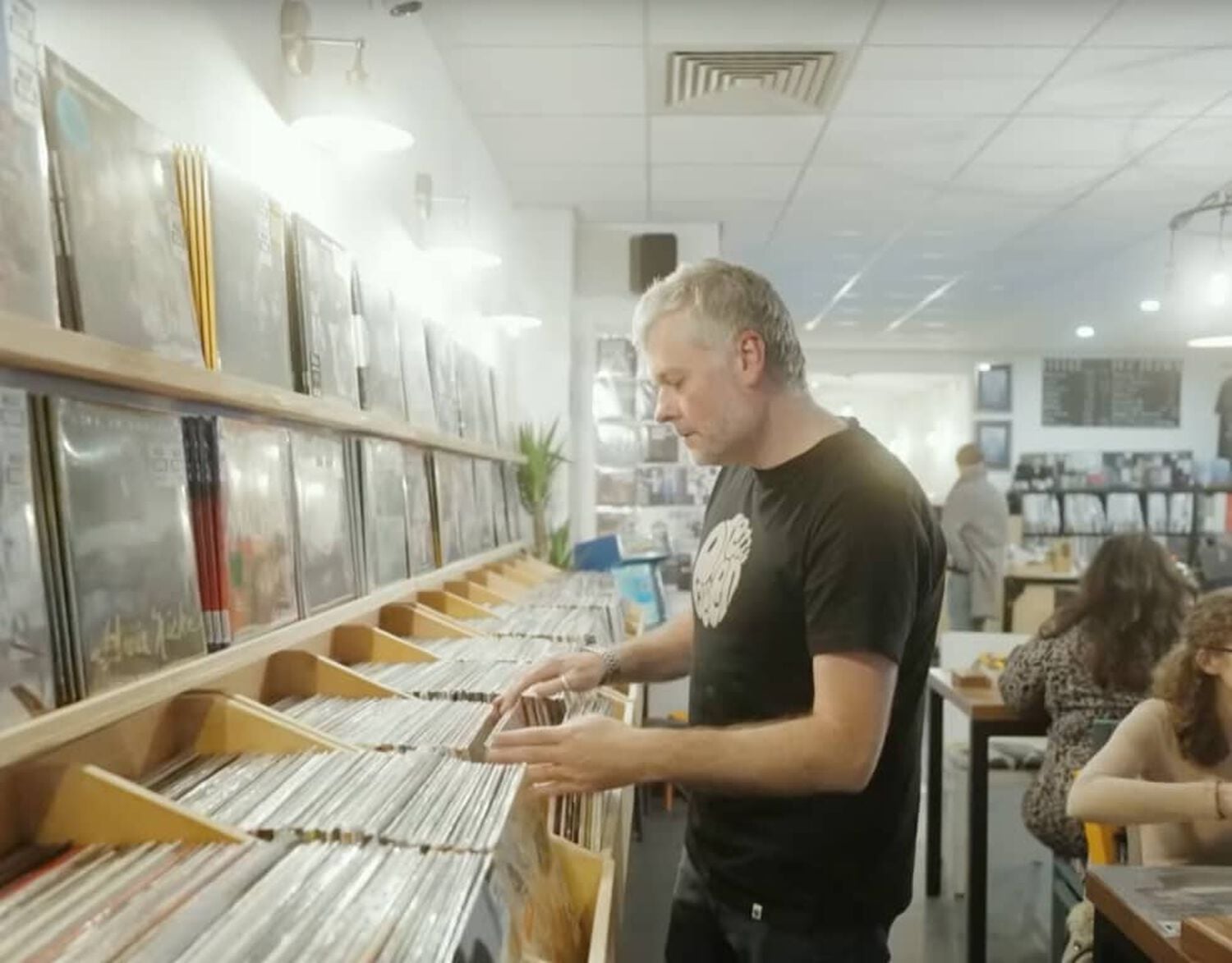 Man looking through records in store