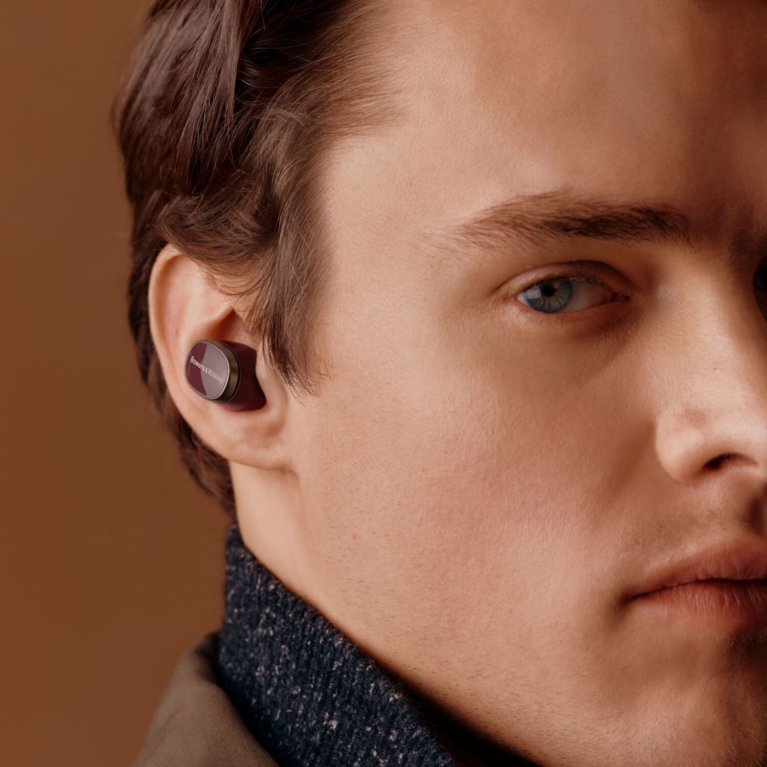 Hear the playlist - man facing left wearing in ear wireless earbuds
