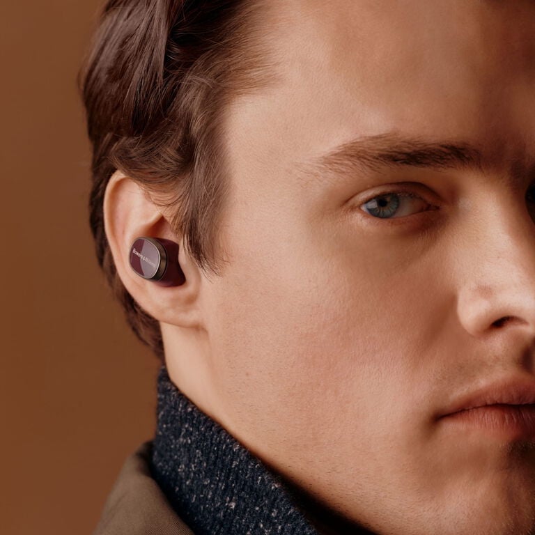 Hear the playlist - man facing left wearing in ear wireless earbuds