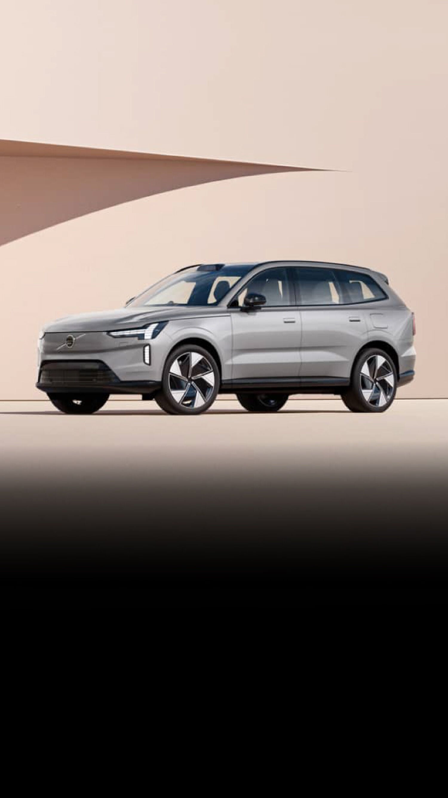 Silver Volvo car facing left on tan background