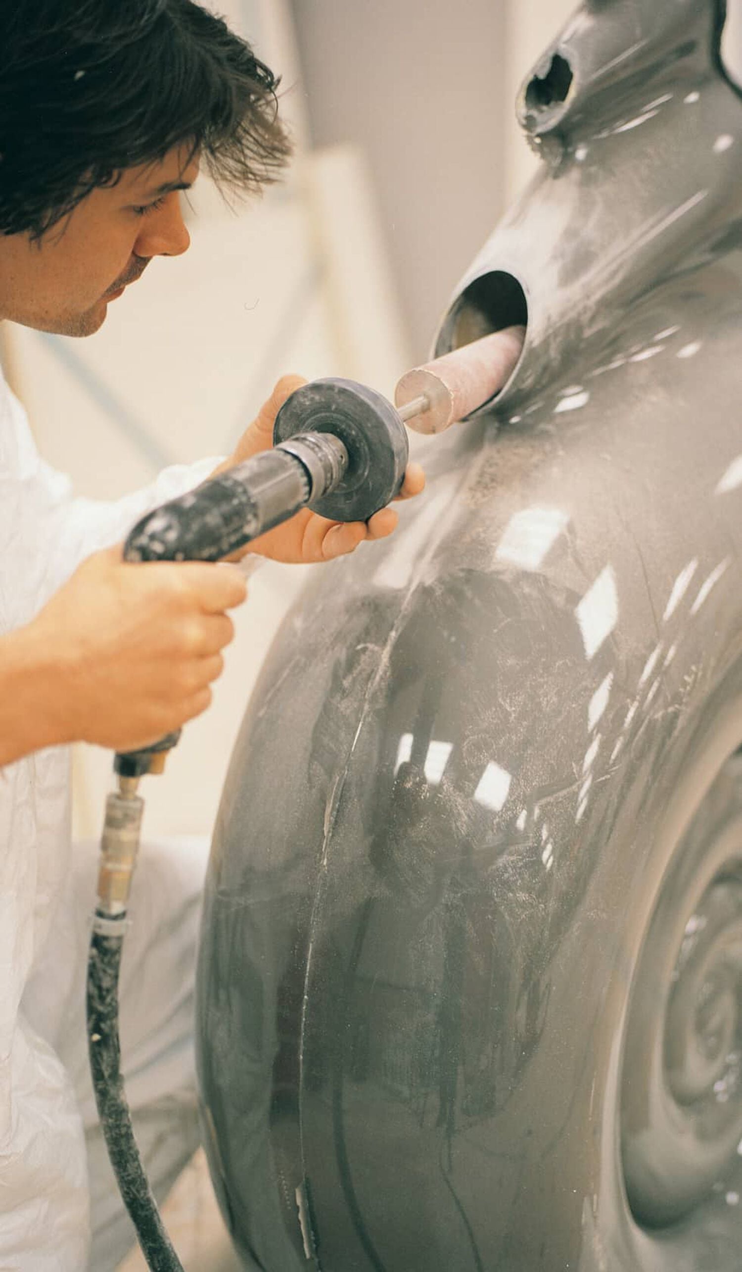 Man sanding interior of Nautilus speaker