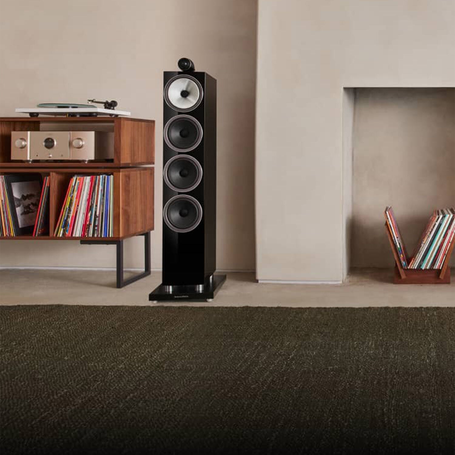 Two black 700 Series loudspeakers surrounding books