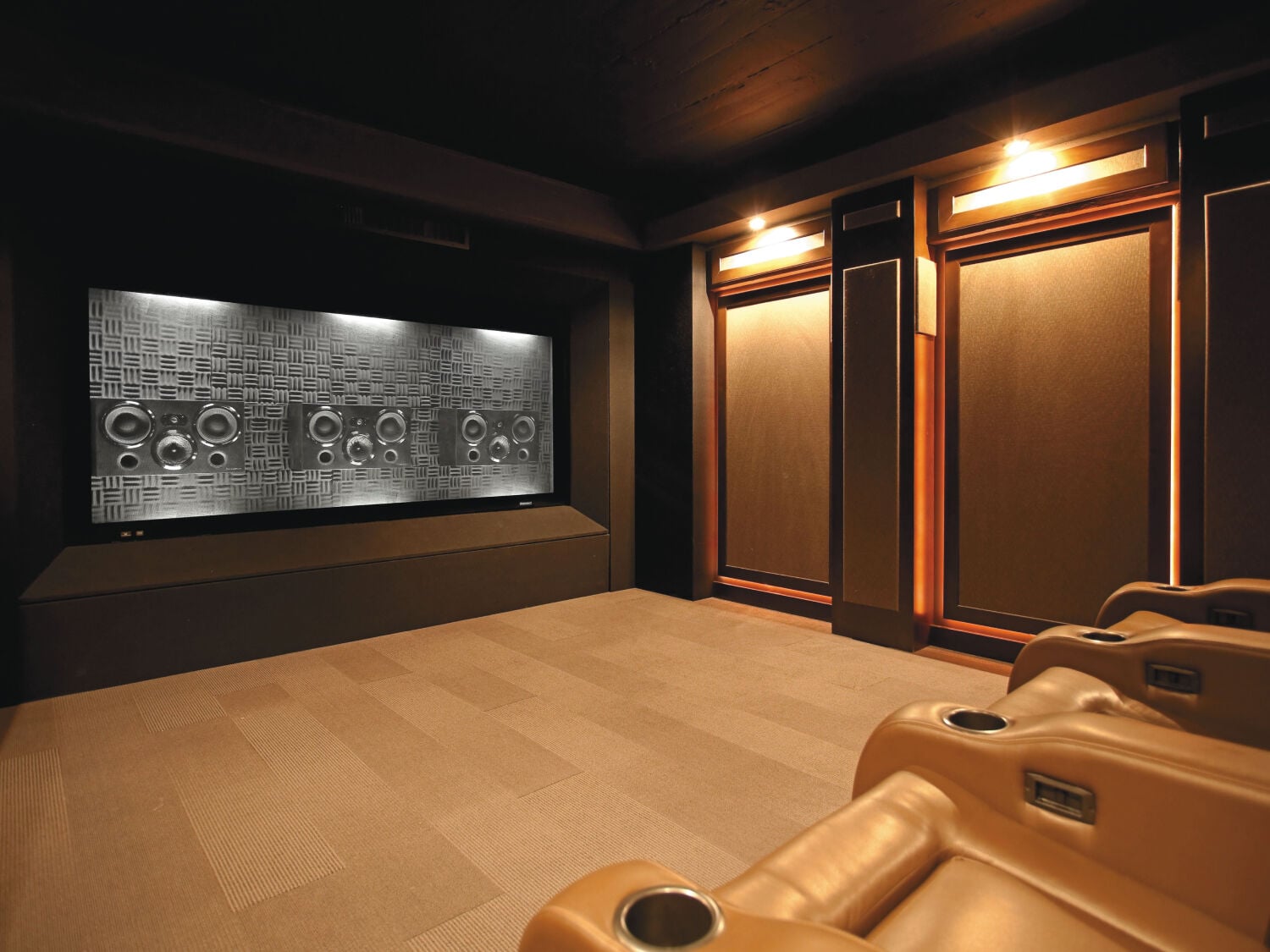 Home theater with speakers behind movie screen