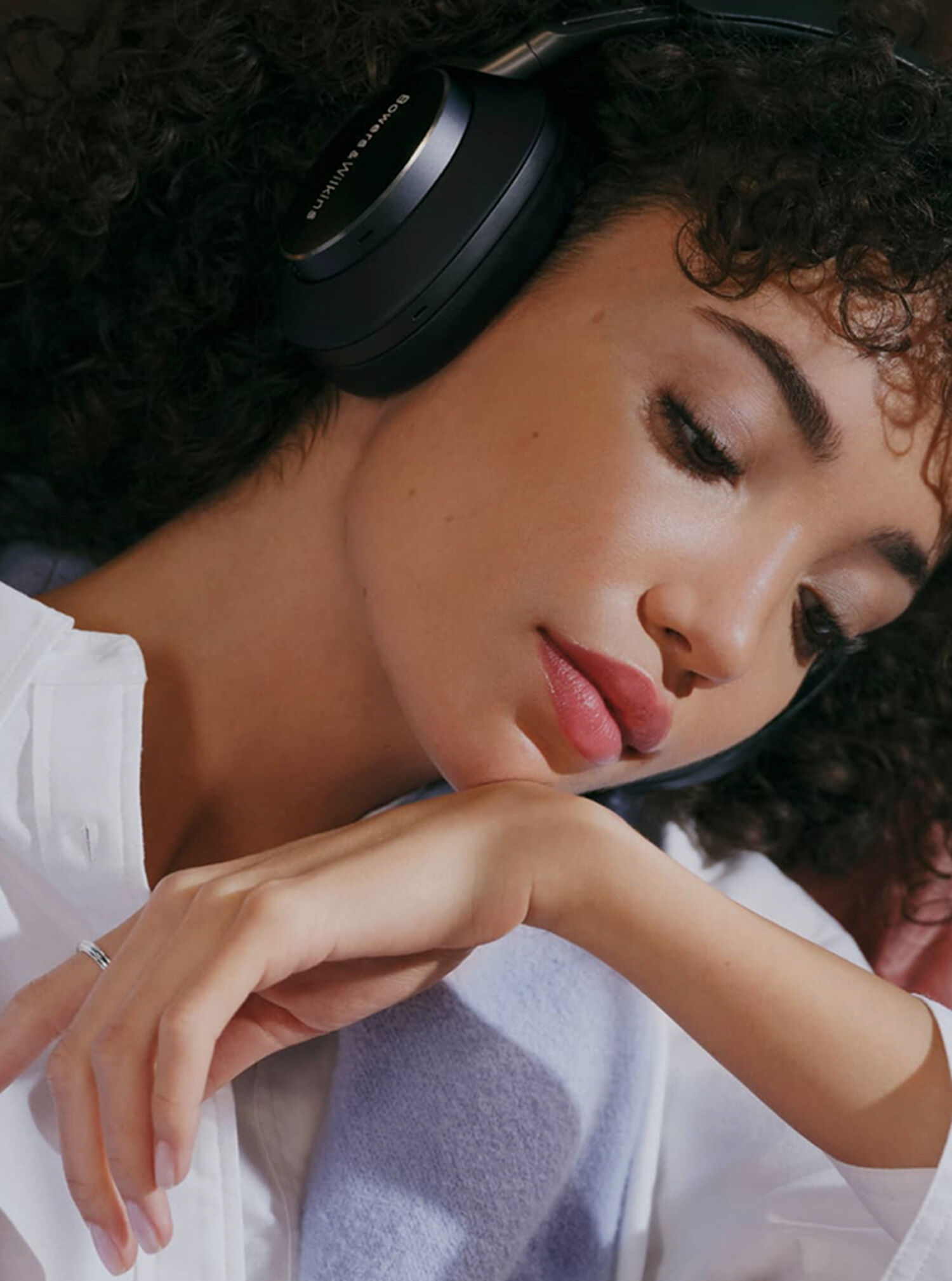 Woman wearing headphones looking down