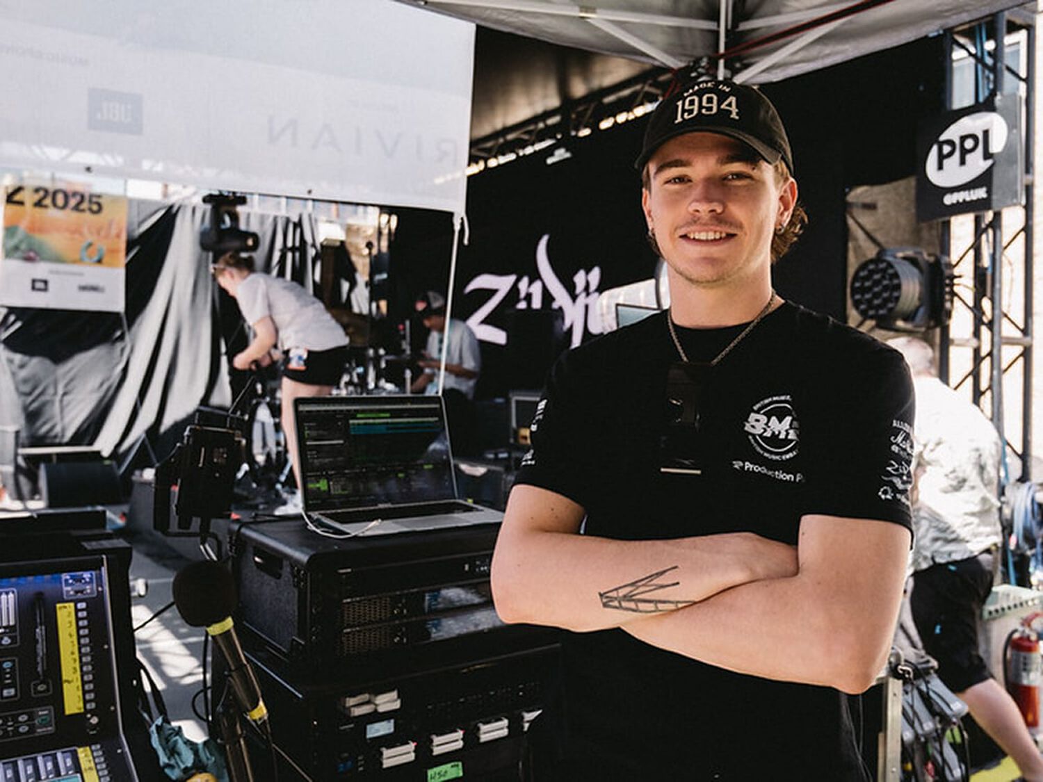 Man posing next to stage equipment
