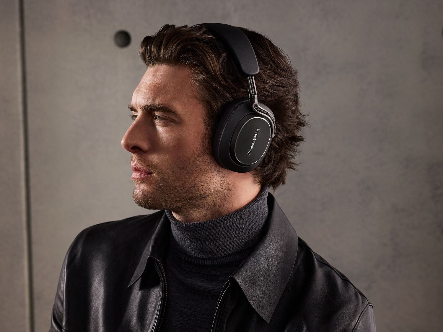 Man wearing headphones facing left