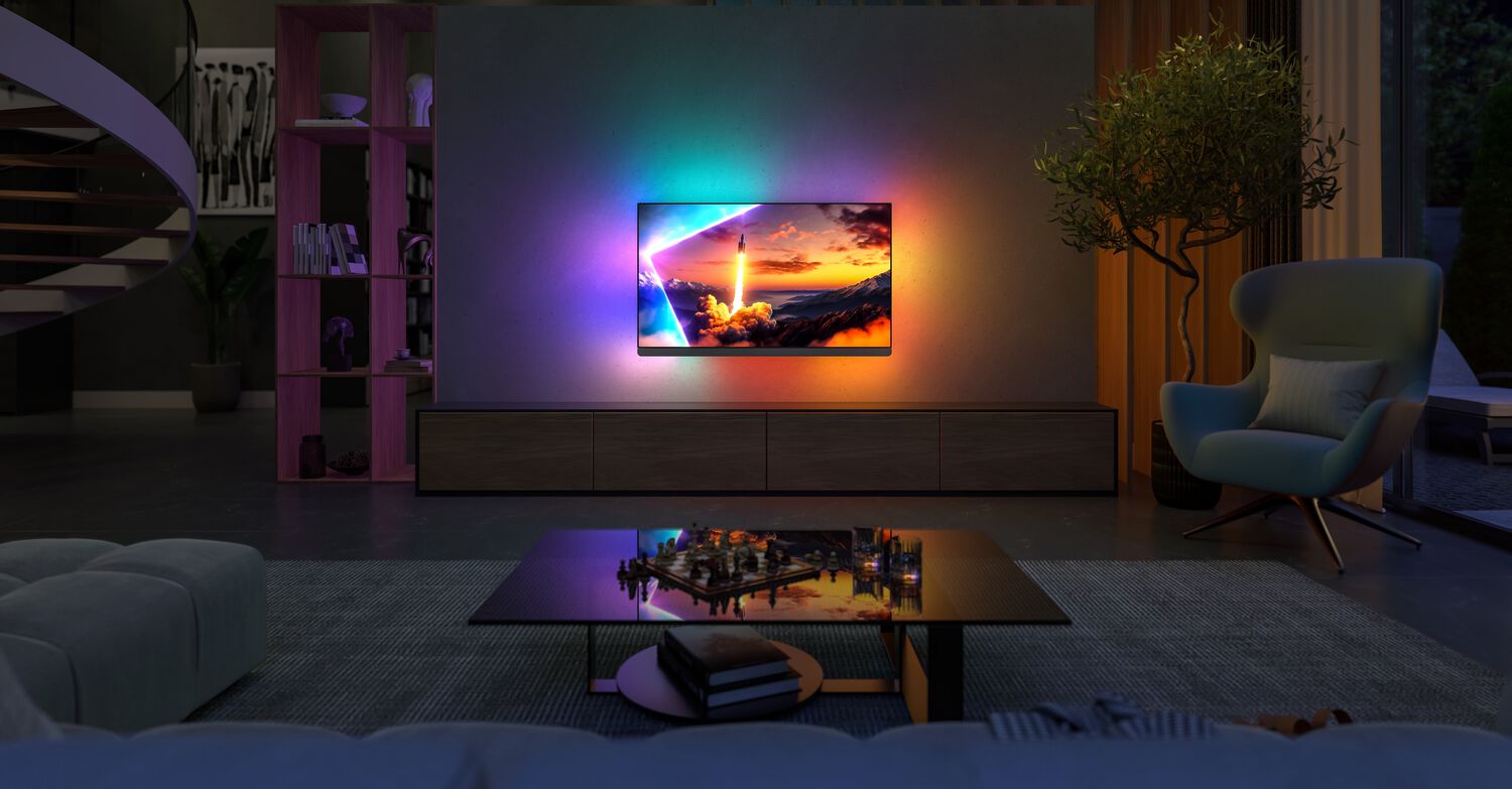 Philips OLED+910 wall mounted in living room with purple, teal and orange lights behind TV