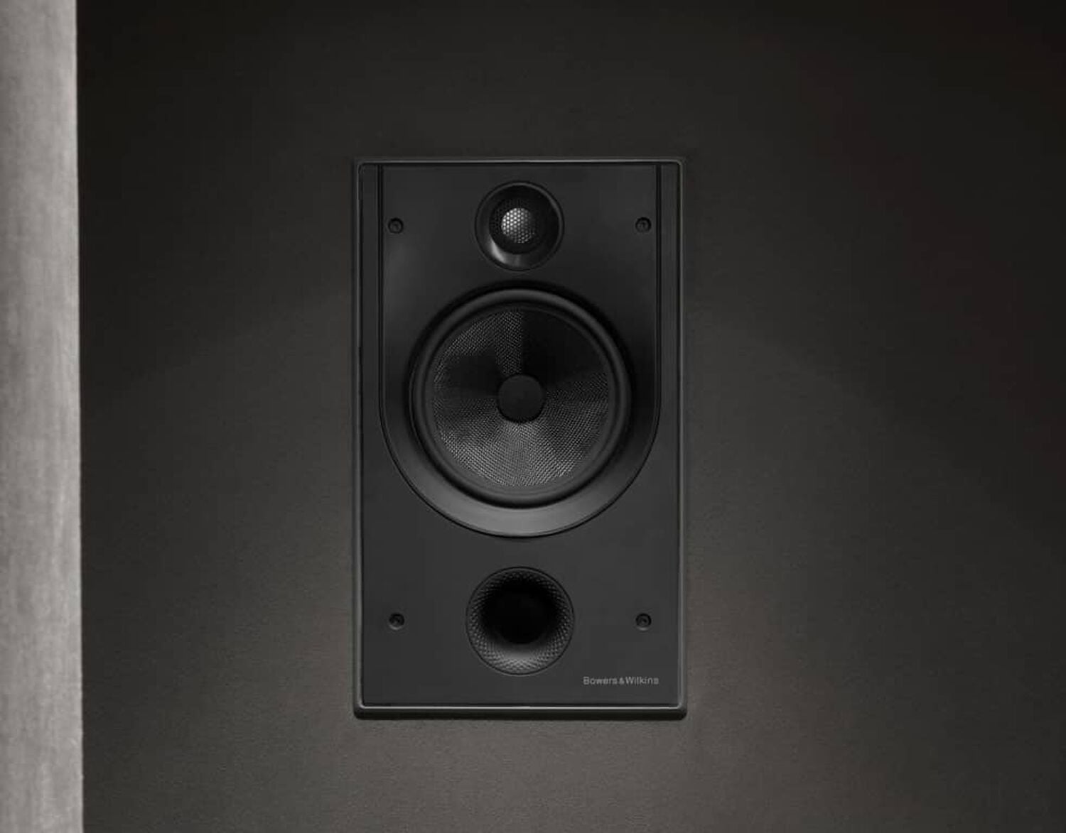 Black speakers embedded into wall