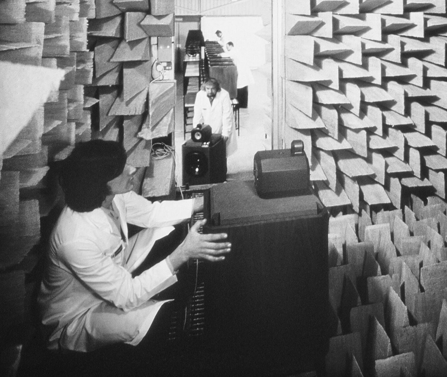 Black and white photo of person holding speaker