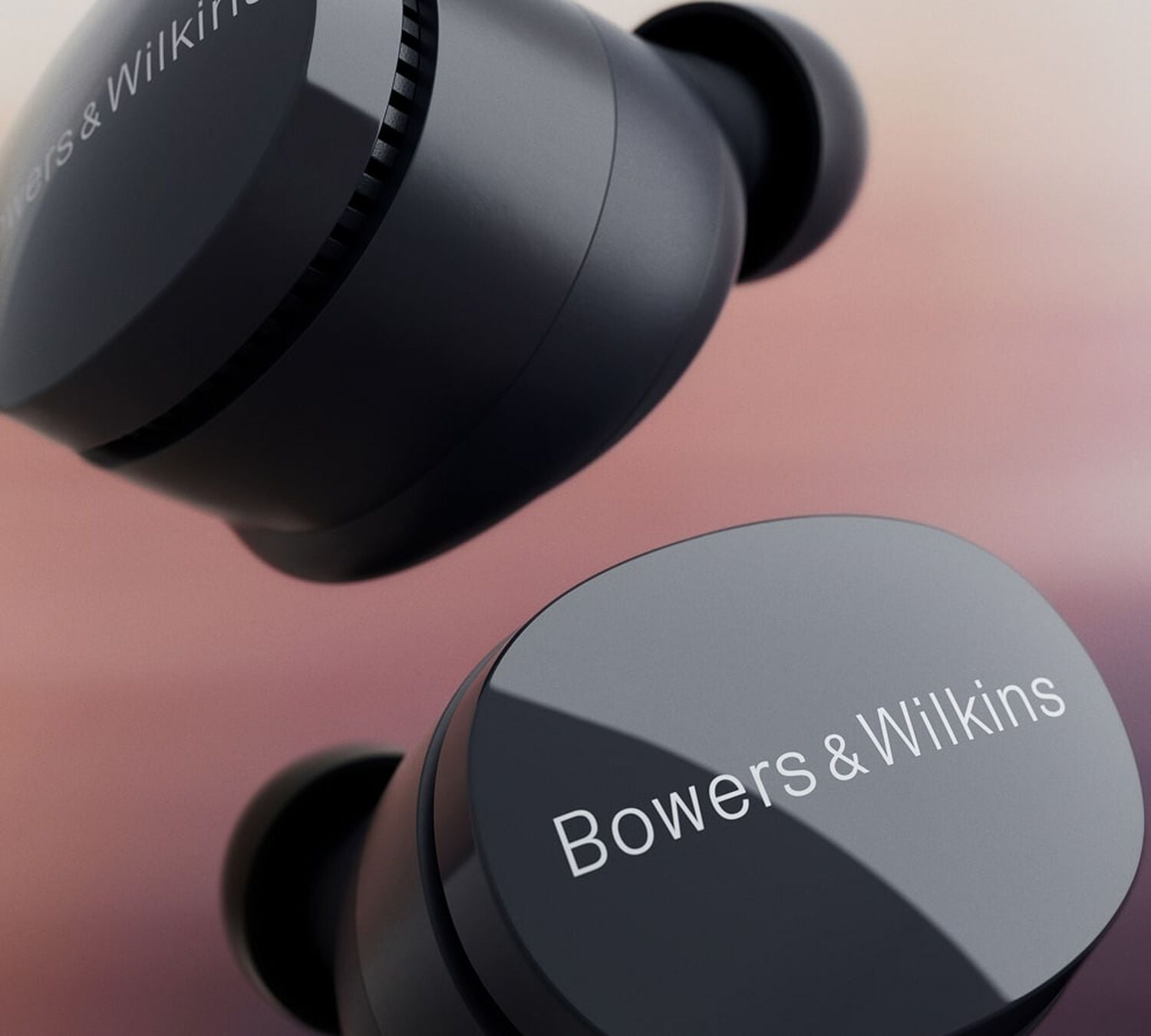 Black Pi6 earbuds with maroon background