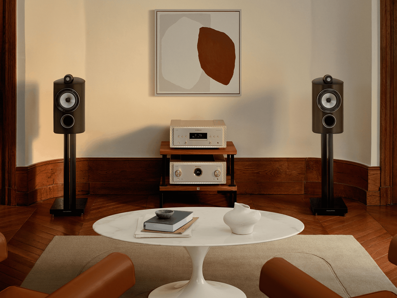 Loudspeakers with Marantz products in between on a shelf facing forward