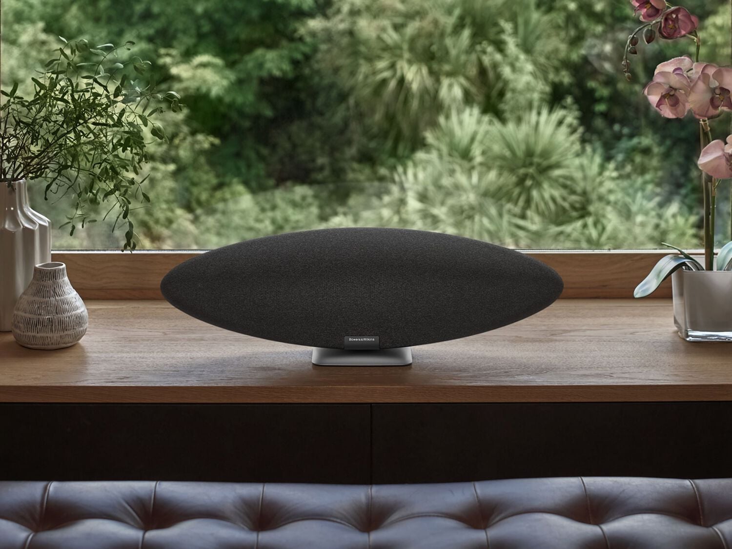 Black wireless speaker front on window sill 