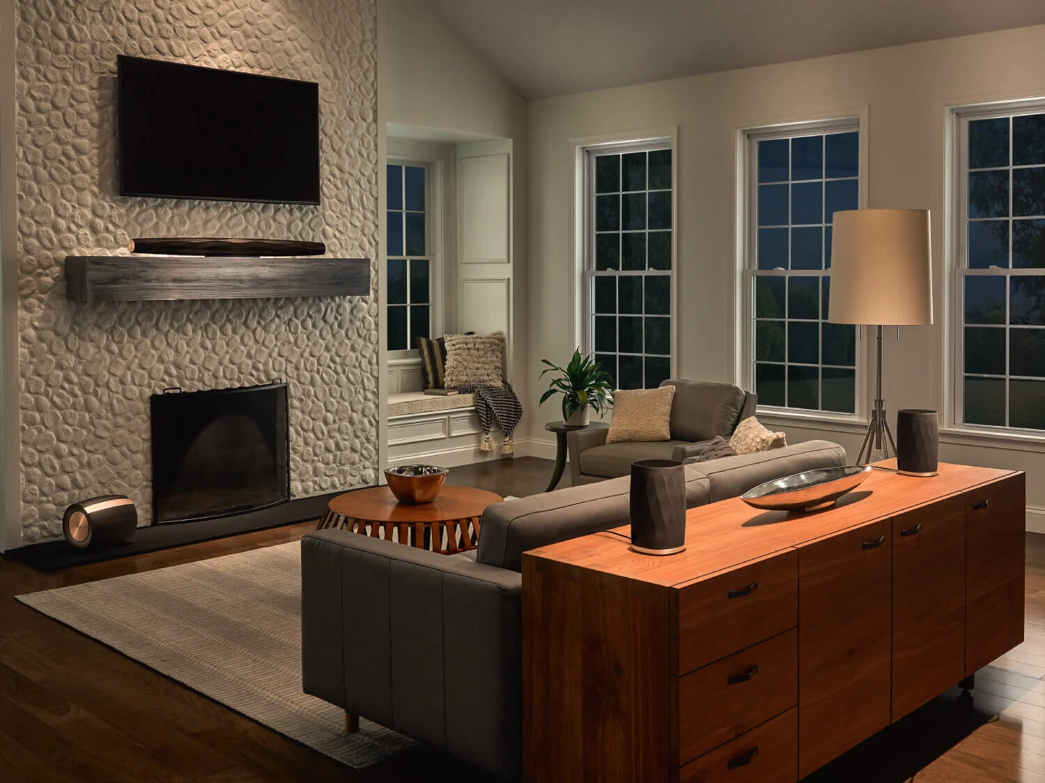 Wireless Home Theater setup in a living room with a mounted television and large windows