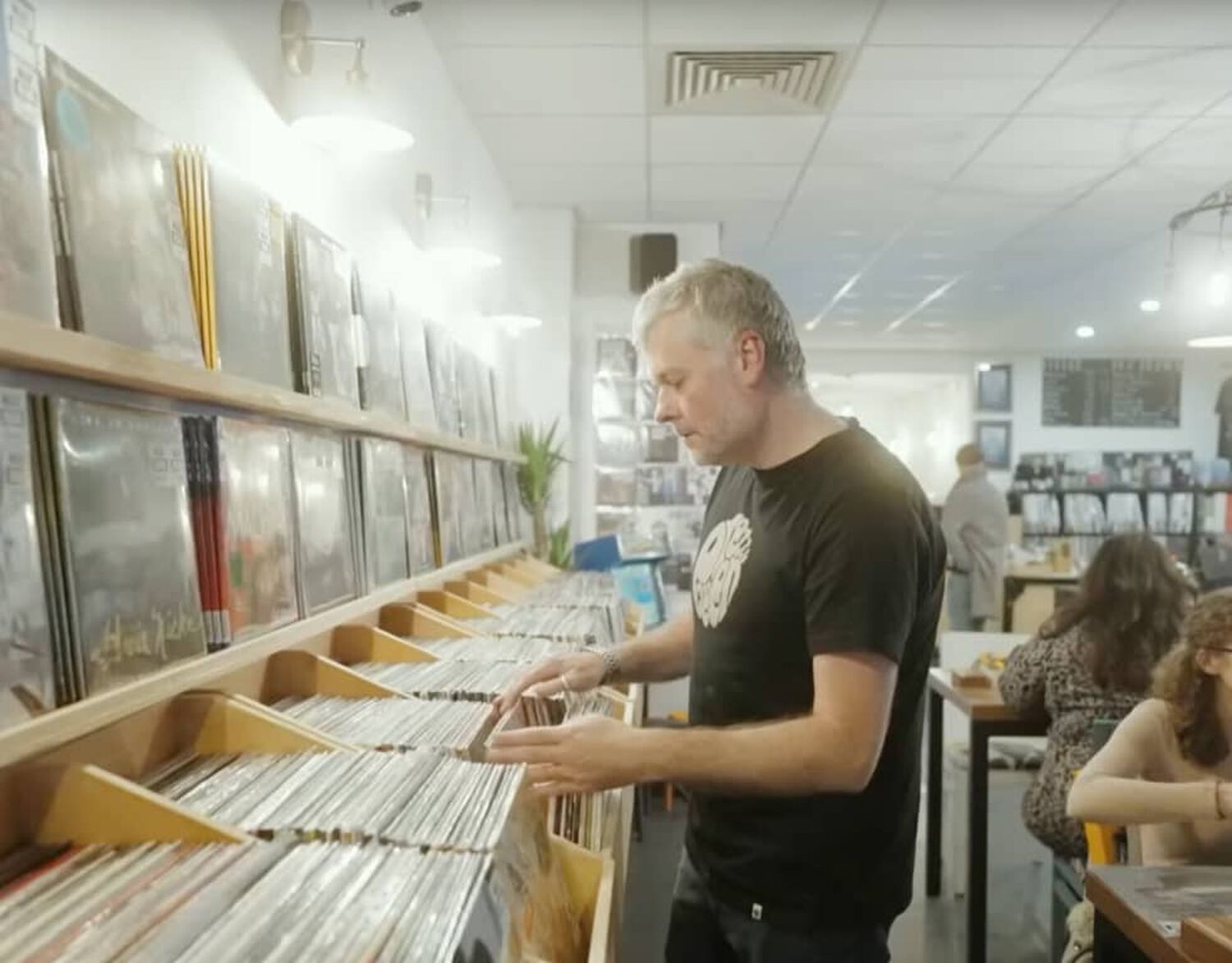 Man looking through records in store