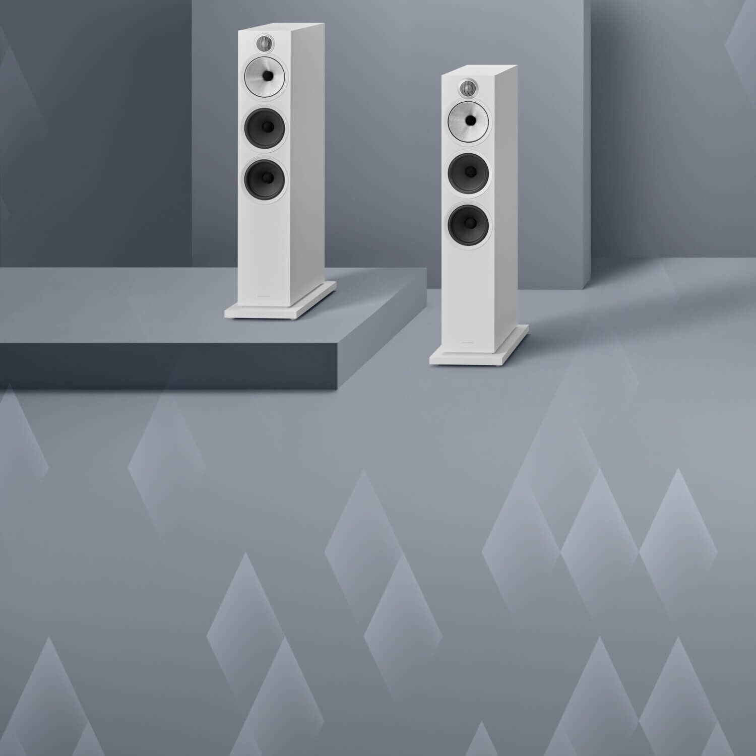 2 white 600 series loudspeakers with blue-gray background