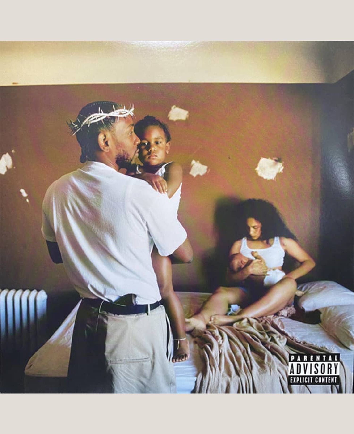 Man and woman holding babies in bedroom