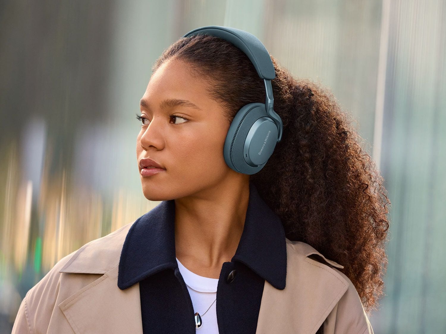 Woman wearing headphones facing left