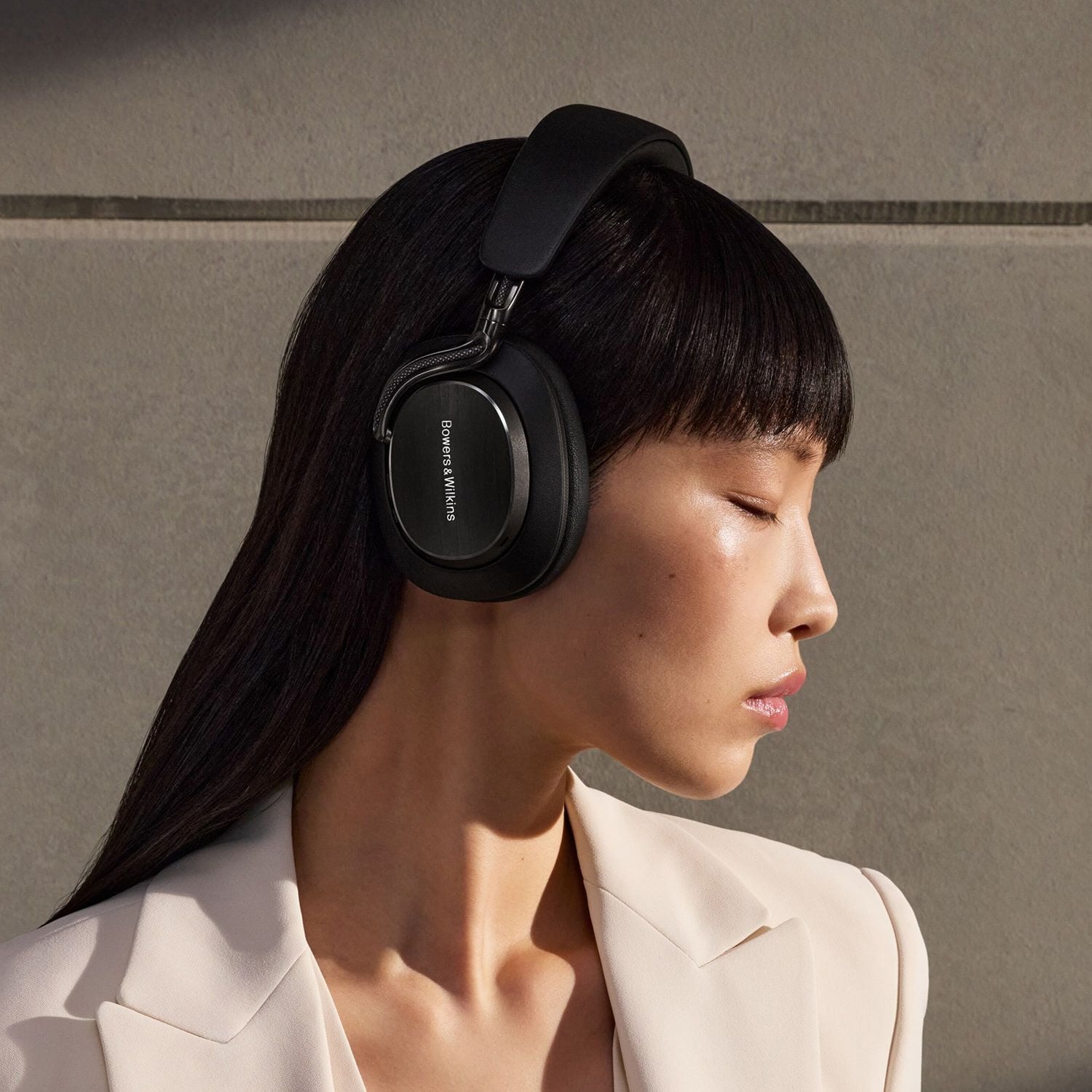 Woman wearing headphones facing right