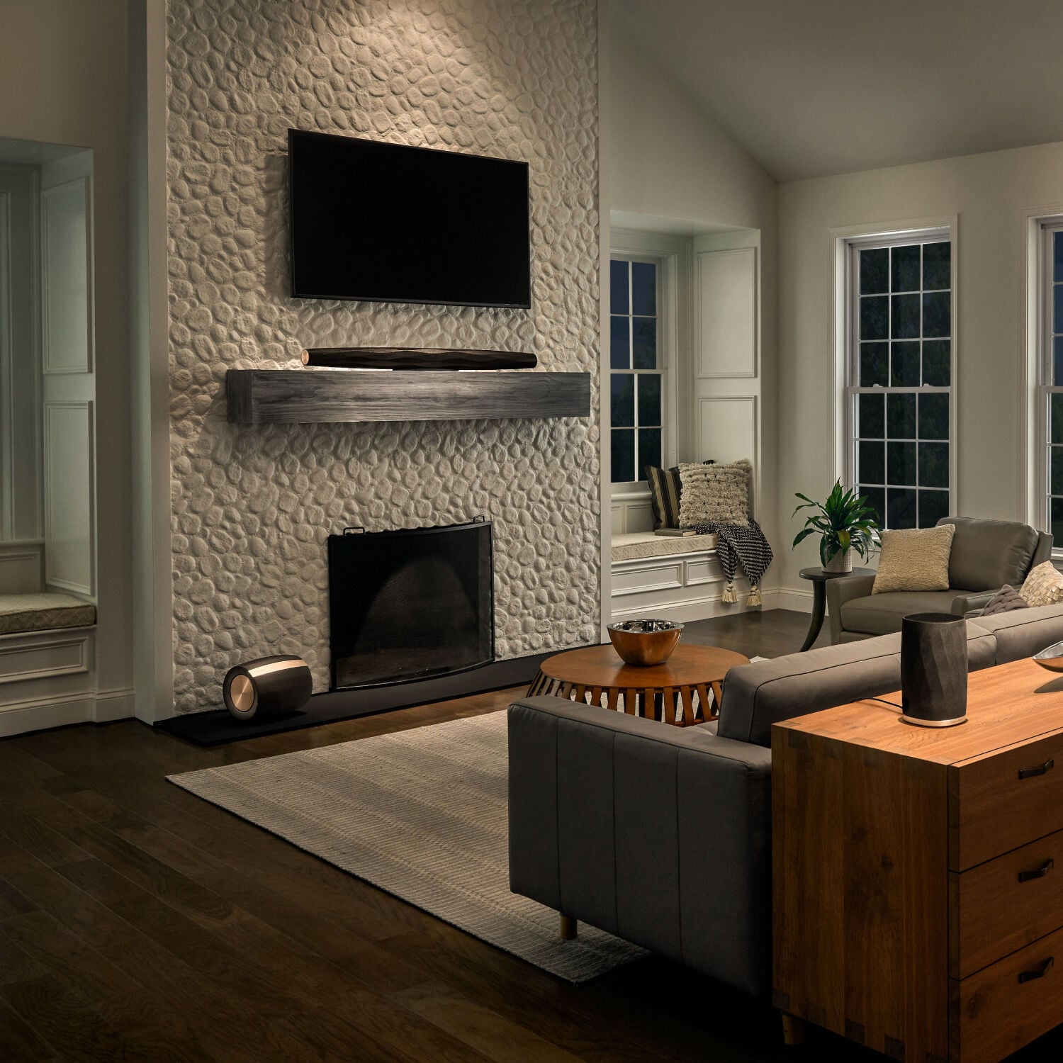 Living room with speakers on console and soundbar on mantle