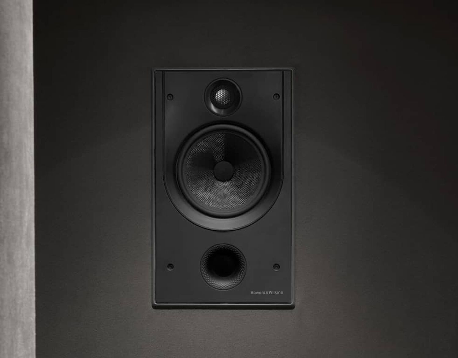Black speakers embedded into wall