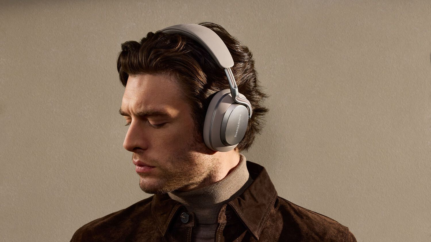 Man wearing headphones facing left