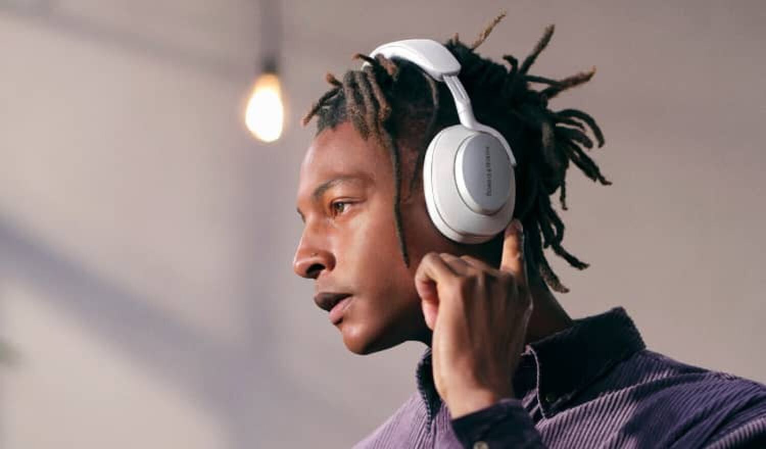 Man wearing headphones facing left