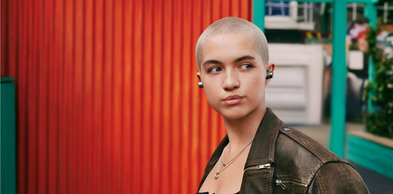 Woman wearing earbuds facing right